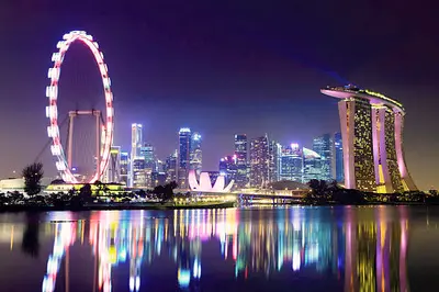 Aerial view of Marina Bay Sands, showcasing its iconic three towers and the SkyPark offering panoramic views of Singapore's skyline and Marina Bay.