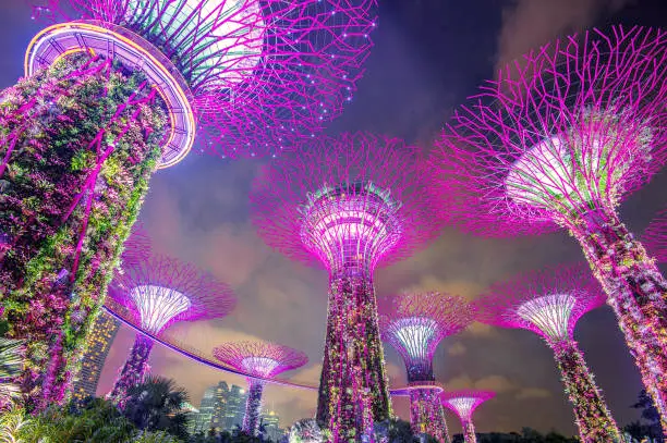 Excited visitors enjoying the thrilling rides and attractions at Universal Studios Singapore on Sentosa Island, with colorful buildings and roller coasters in the background, showcasing the excitement and entertainment of the theme park.